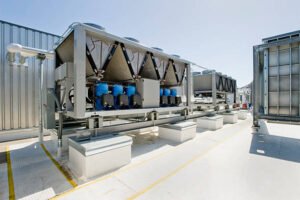 Rooftop cooling unit with chiller units and compressors.
